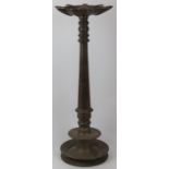 An Indian bronze floor standing temple 'Puja' oil lamp with nine wick diya reservoir, 19th