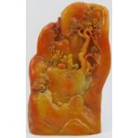 A Chinese finely carved faux amber landscape mountain scene, 20th century. Carved depicting a