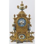 A French ormolu and porcelain mantle clock, 19th century. Modelled in the Neoclassical style with