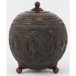 An Anglo Indian carved coconut tea caddy, late 19th/20th century. Carved with bands of decoration