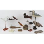 A group of eight hand carved and painted wooden sculptures of birds on stands. (8 items) 46 cm