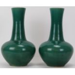 A pair of Chinese style apple green glazed ceramic vases, 20th century. (2 items) 31.3 cm height.