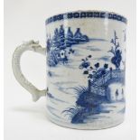 A Chinese export blue and white porcelain tankard, late 18th century. With a dragon moulded
