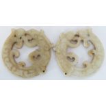 A pair of Chinese carved jade coiled dragon and pearl pendants, 20th century. Carved in a similar