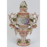 A German Sitzendorf porcelain twin handled vase and cover. Profusely decorated and modelled in