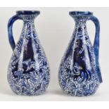 A pair of Art and Crafts blue and white ceramic jugs, late 19th/early 20th century. Decorated with