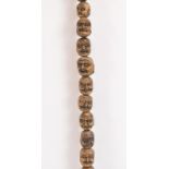 A collection of Japanese carved wood ojime type beads, early 20th century. Comprising thirty two