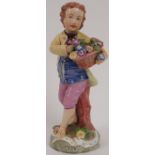 A European porcelain figurine of a boy with flowers, probably early 19th century. Bearing Austrian