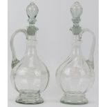A pair of Victorian clear glass decanters. With original stoppers. Decorated with a swirling