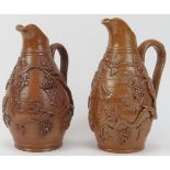 A matched pair of Victorian stoneware wine jugs. With vine leaf and berry relief moulded decoration.