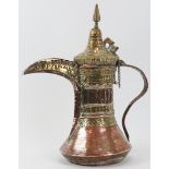A Middle Eastern copper and brass Dallah, 19th century or earlier. Embossed with a variety of