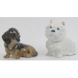 Two Royal Copenhagen porcelain dogs. Comprising a West Highland Terrier and a Dachshund. Both marked