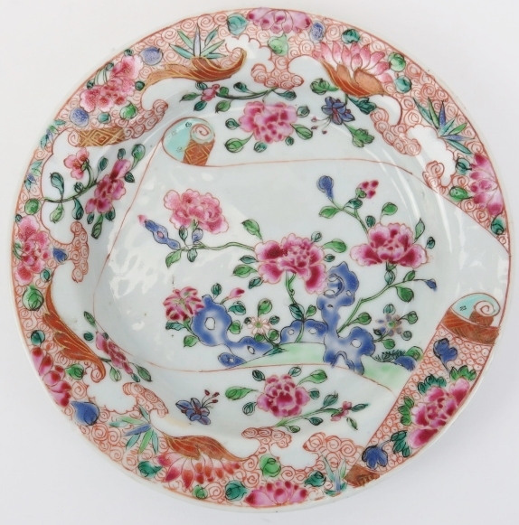 A Chinese Famille rose dish, mid 18th century. Enamel decorated with peonies issuing from a rocky