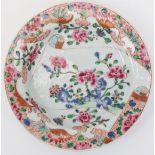A Chinese Famille rose dish, mid 18th century. Enamel decorated with peonies issuing from a rocky