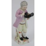 A German KPM porcelain figurine of a boy holding a birds nest, late 18th/early 19th century. KPM