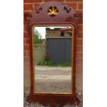 A Georgian mahogany parcel gilt wall mirror, within a shaped surround featuring carved and pierced