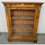 A 19th century walnut pier cabinet with marquetry inlay and gilt metal mounts, the glazed door