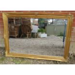 An antique style rectangular bevelled wall mirror, within a gilt gesso moulded surround. Fittings