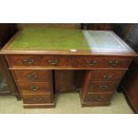 An Edwardian flame mahogany kneehole desk, with inset green leather writing surface, housing eight