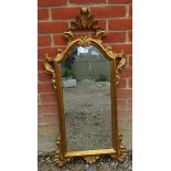 A vintage giltwood Italian wall mirror, in a shaped and pierced surround depicting acanthus