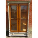 An antique continental pine glazed display cabinet of three loose shelves