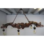 A novelty pendant ceiling light, formed of an antique elm and cast-iron yoke with six light
