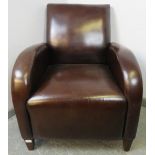 An Art Deco style club armchair, upholstered in brown leather, on tapering square coromandel