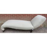 A Victorian chaise longue of small proportions, re-upholstered in Art Deco style patterned material,