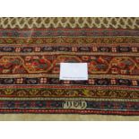 A 20th century Persian rug with central block pattern on cream ground. Condition and colour good.