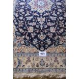 A 20th century Nain rug, with a central 8 point burst motif, blue on cream ground and in good