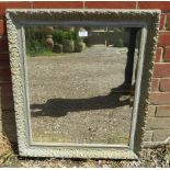 An antique gesso bevelled wall mirror, the moulded surround painted grey and distressed. H75cm W66cm