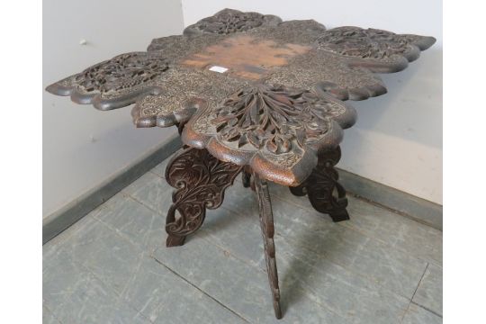 A well carved antique Anglo-Indian hardwood folding table, the shaped top with relief carving - Image 2 of 3