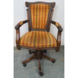 An Edwardian style mahogany captain’s swivel and height adjust desk chair with carved frame and