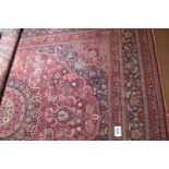 An early 20th century Persian carpet with a large central motif. 322 x 416cm. Some slight wear in
