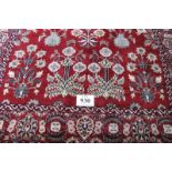 A 20th century Gabbeh rug, deep red ground with foliage/flowers in cream. 230 x 153cm and in