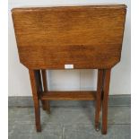 An Edwardian medium oak Sutherland table, on square supports with small brass castors. H69cm W46cm