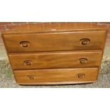 A mid-century blonde elm Windsor chest by Ercol (model 412) housing three long drawers, raised on