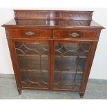 A good quality Edwardian mahogany glazed bookcase, with reeded gallery, housing two cock-beaded