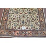 A central Persian Sarouk rug with central floral pattern on cream ground. 2.10 x 130. Very clean