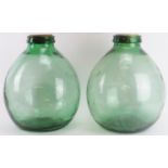 Two large Viresa green glass carboys, 20th century. Also referred to as demijohns. Both marked ‘