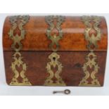 A Victorian brass mounted burr walnut veneered tea caddy. The domed cover with pierced brass mounted