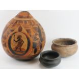 Tribal Art: Three African vessels, 20th century. Comprising a large carved calabash water container,