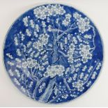 A Chinese blue and white porcelain charger decorated with blossoming prunus, 19th century. 34.5 cm