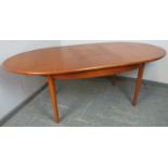 A mid-century teak oval extending dining table by G-Plan, with butterfly folding central leaf, on