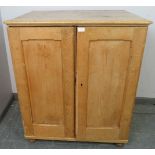 An antique stripped pine pantry cupboard, housing four pull out slides, on bun feet. H103 W88 D65