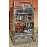 A vintage Jubilee 'Riviera' chromed one-armed bandit penny slot machine. Includes vintage coins