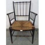 A 19th century ebonised beech William Morris ‘Sussex’ chair, with rush seat, on tapering supports