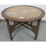 An antique hardwood Anglo Indian Kashmiri folding table, the top with hand-tooled brass tray