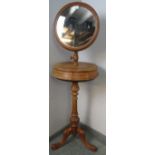 A Victorian walnut Gentleman’s shaving stand, having a circular height-adjustable mirror above two