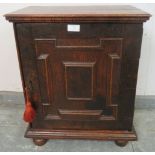 A good 17th century oak spice cupboard, the door with geometric mouldings opening onto a